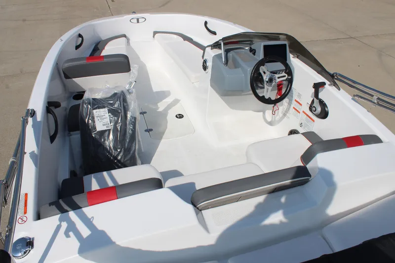 Slide: The Image of 2023 Tahoe T16 boat interior with modern steering and seating design. - 9