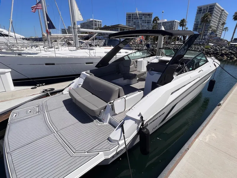 Slide: The Image of 2019 Cruisers Yachts 338 IO docked, featuring sleek design and spacious deck. - 1