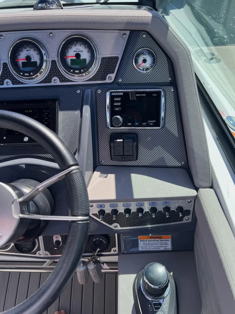 Slide: The Image of 2019 Cruisers Yachts 338 IO dashboard with steering wheel and control panel. - 10