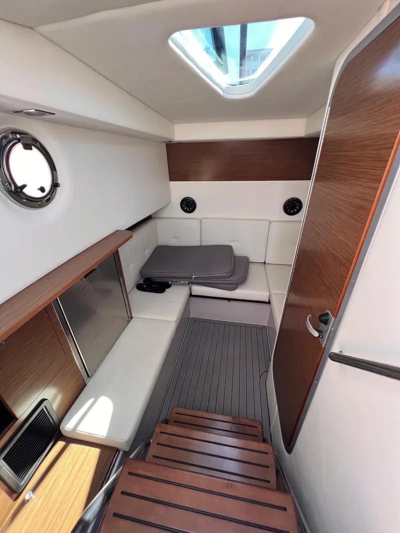 Slide: The Image of 2019 Cruisers Yachts 338 IO cabin interior with modern wood and white upholstery. - 26