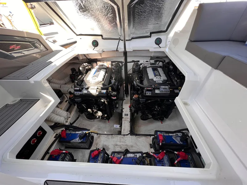 Slide: The Image of Engine compartment of 2019 Cruisers Yachts 338 IO, showcasing dual engines and battery setup. - 38