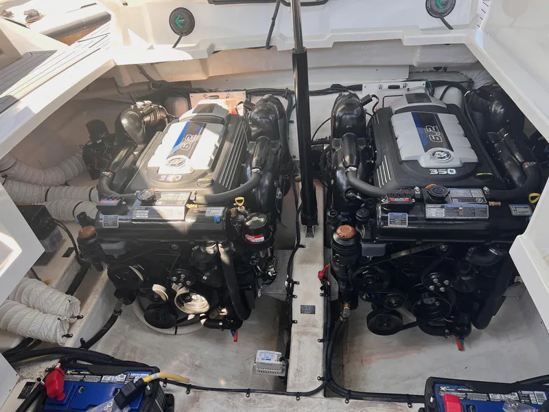Slide: The Image of Engine compartment of a 2019 Cruisers Yachts 338 IO, featuring dual powerful engines. - 39