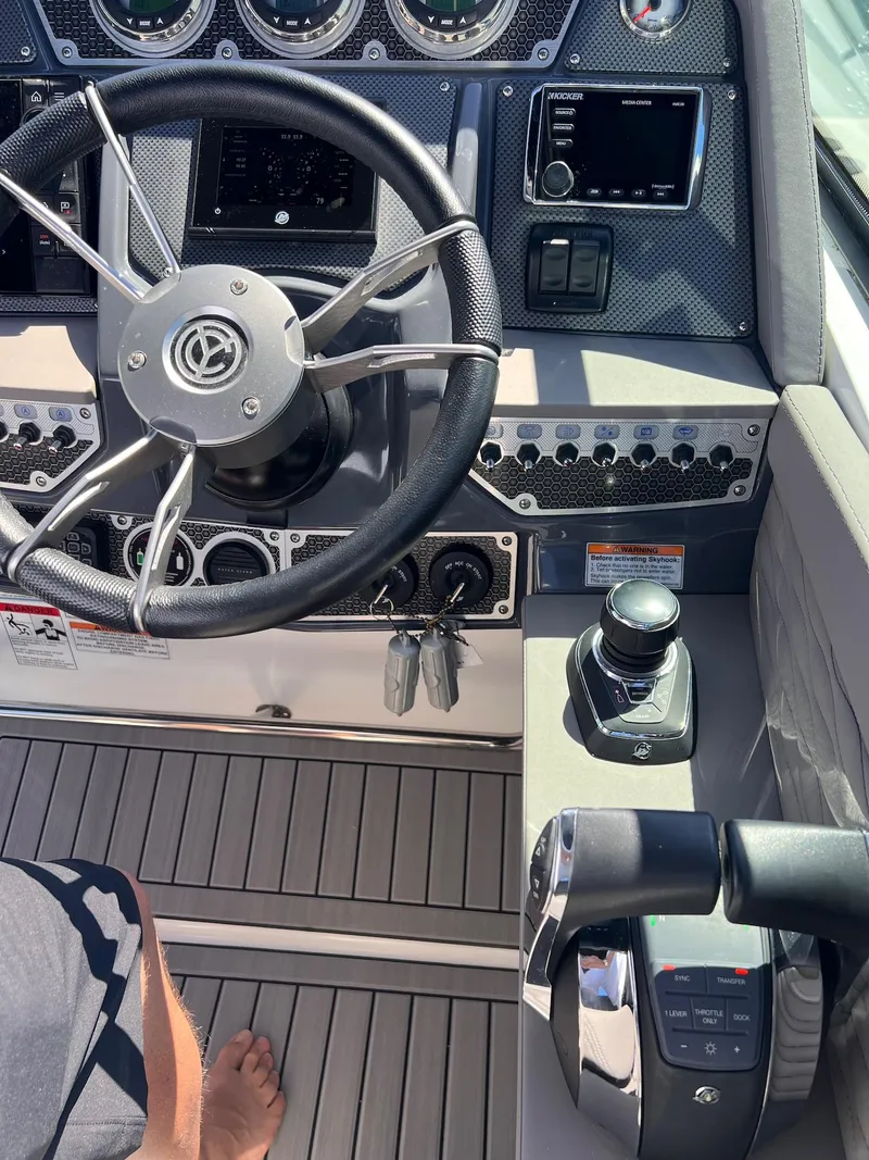 Slide: The Image of 2019 Cruisers Yachts 338 IO helm with steering wheel and control panel. - 9