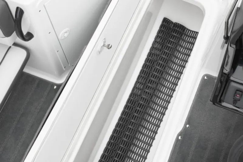 Slide: The Image of 2026 Yamaha Boats AR190 interior storage compartment with black mat and seating area. - 3
