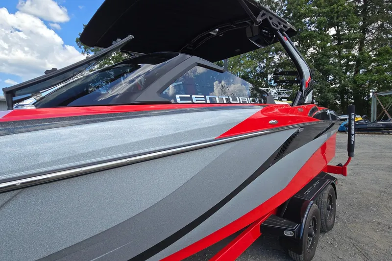 Slide: The Image of 2022 Centurion Fi23 boat with sleek red and gray design, parked outdoors. - 10