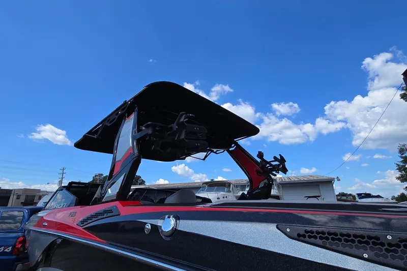 Slide: The Image of 2022 Centurion Fi23 boat with tower against blue sky and clouds. - 16