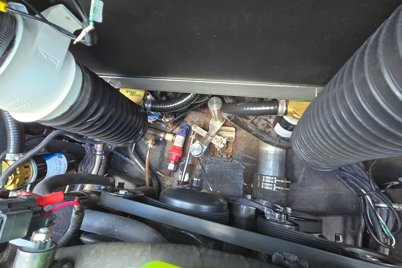 Slide: The Image of Engine compartment of a 2022 Centurion Fi23 boat, showcasing hoses and components. - 20