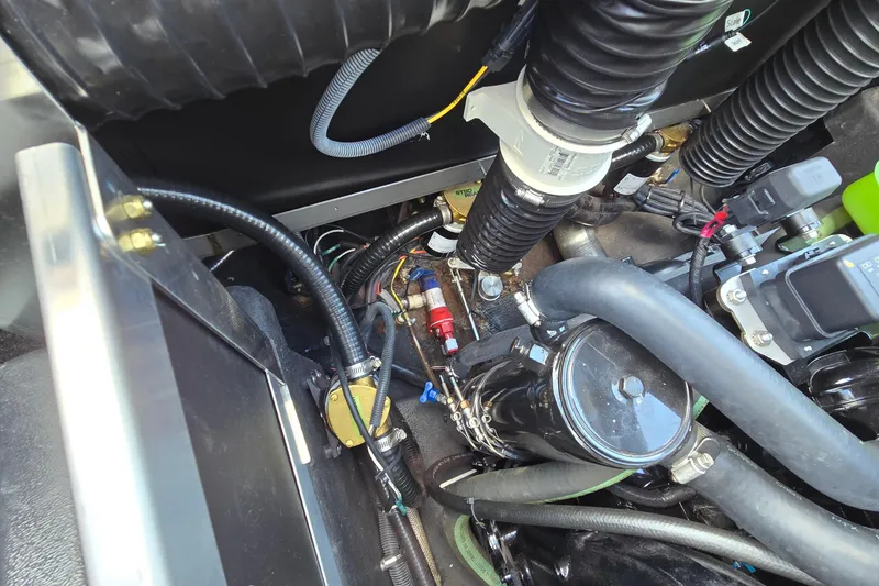 Slide: The Image of 2022 Centurion Fi23 engine compartment with hoses and mechanical components. - 21