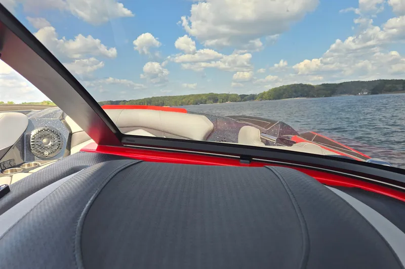 Slide: The Image of 2022 Centurion Fi23 boat interior with lake view, featuring sleek design and comfortable seating. - 30