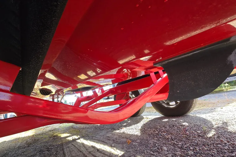 Slide: The Image of Underside view of a 2022 Centurion Fi23 boat on a red trailer. - 38