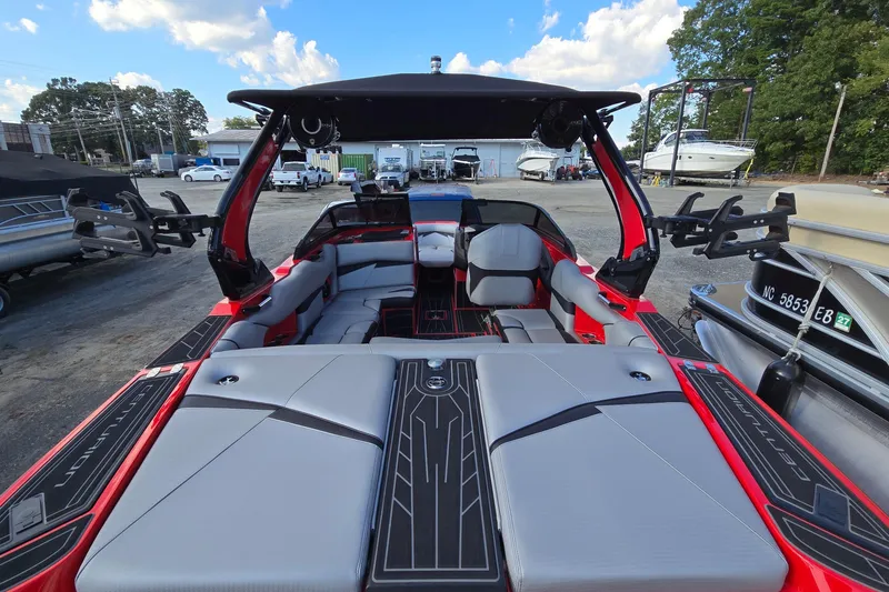 Slide: The Image of 2022 Centurion Fi23 boat interior with sleek seating and modern design in a marina setting. - 41