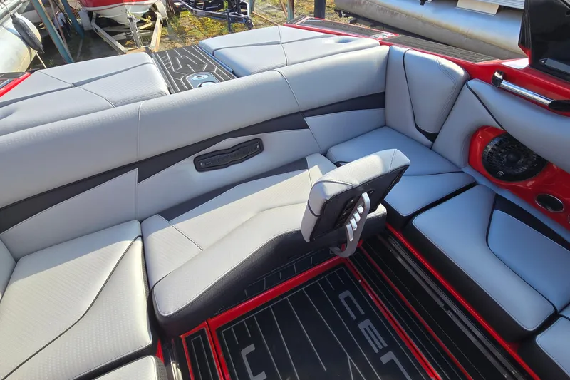 Slide: The Image of 2022 Centurion Fi23 boat interior with gray seating and red accents. - 44