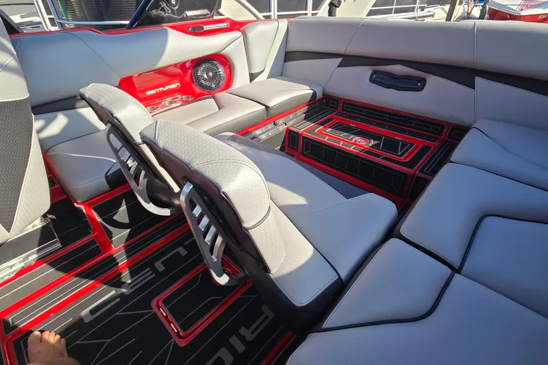 Slide: The Image of 2022 Centurion Fi23 boat interior with sleek gray and red seating and modern design. - 45
