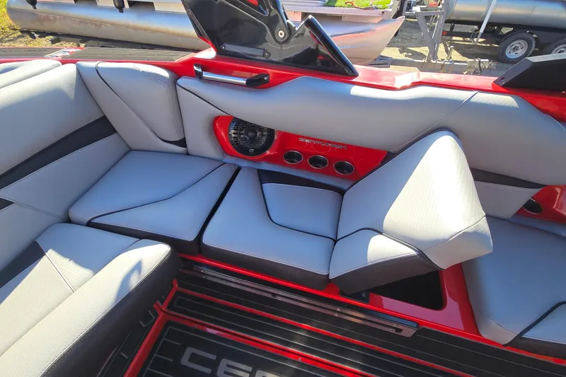 Slide: The Image of 2022 Centurion Fi23 boat interior with gray seating and red accents. - 60