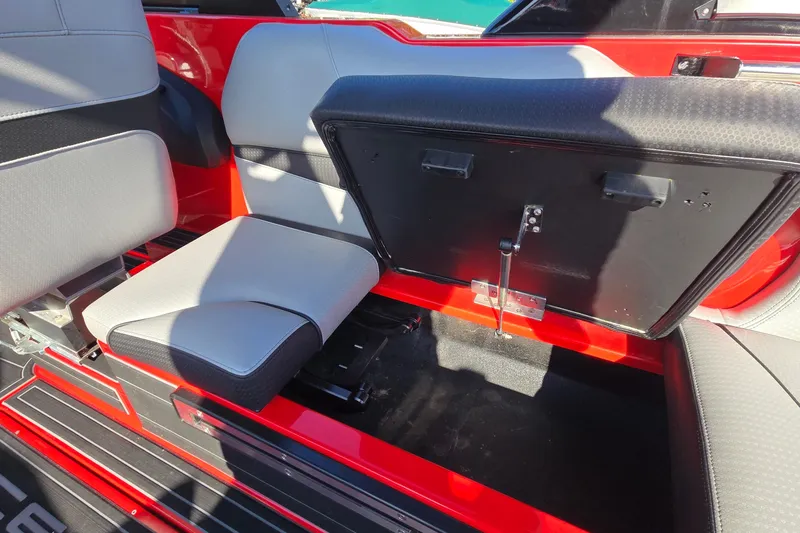 Slide: The Image of 2022 Centurion Fi23 boat interior with open storage compartment and seating. - 61