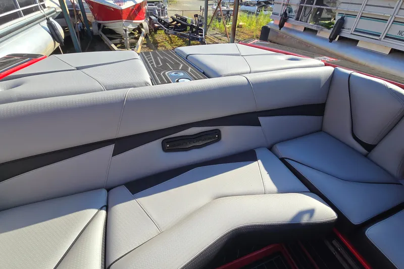 Slide: The Image of 2022 Centurion Fi23 boat interior with gray seating and sleek design. - 63