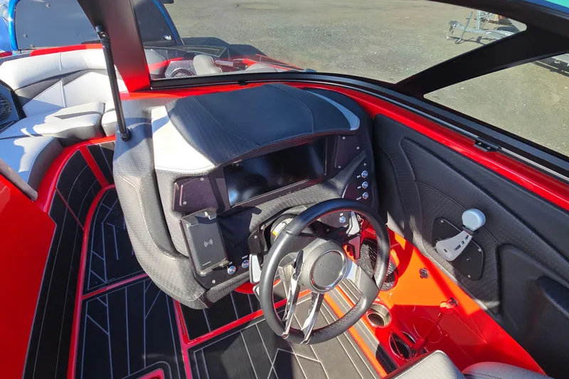 Slide: The Image of 2022 Centurion Fi23 boat interior with sleek dashboard and steering wheel design. - 66