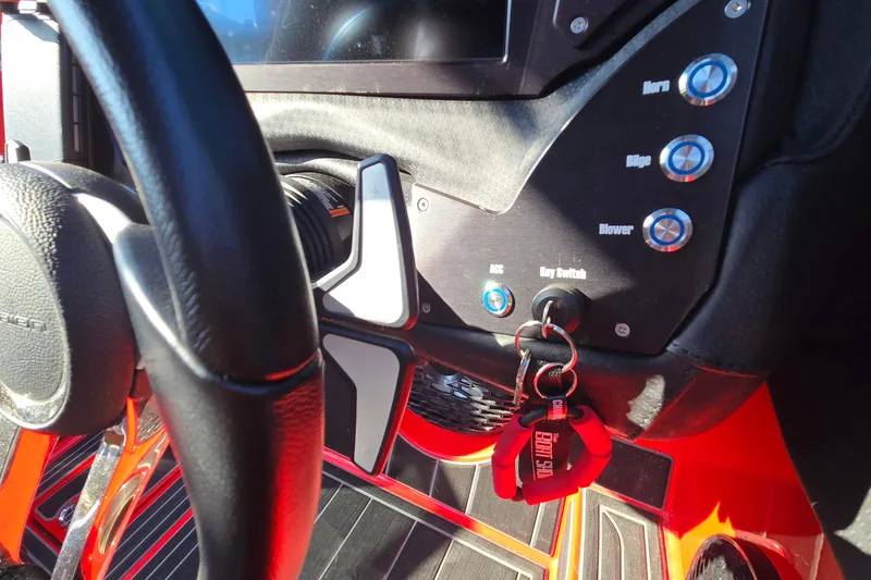 Slide: The Image of 2022 Centurion Fi23 dashboard with steering wheel, control buttons, and key switch. - 68