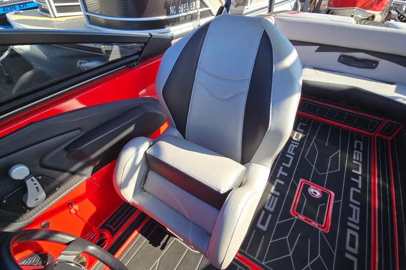Slide: The Image of 2022 Centurion Fi23 boat interior with gray seat and red accents. - 69