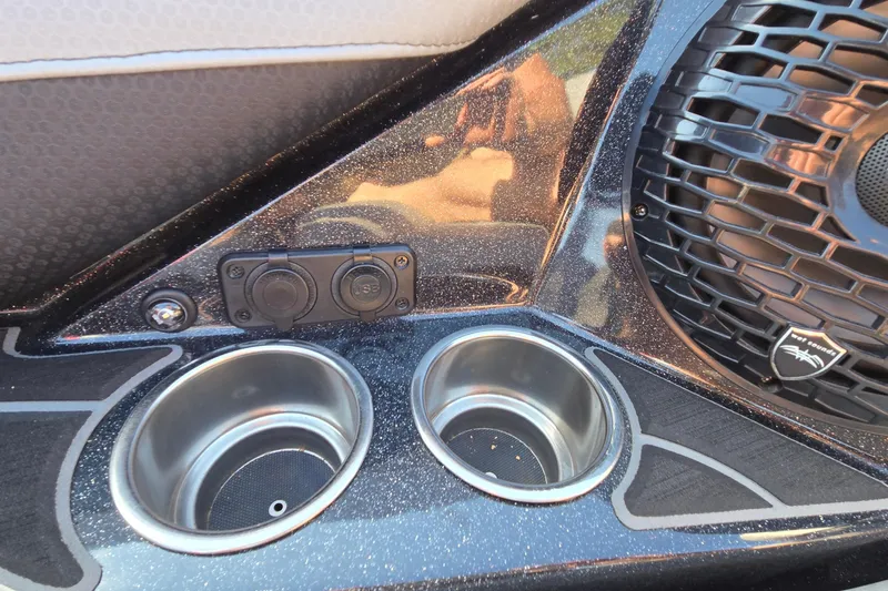 Slide: The Image of 2022 Centurion Fi23 boat interior with cup holders and speaker detail. - 77