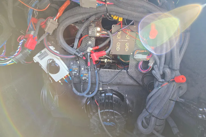 Slide: The Image of 2022 Centurion Fi23 boat wiring and electrical components with visible cables and connectors. - 79