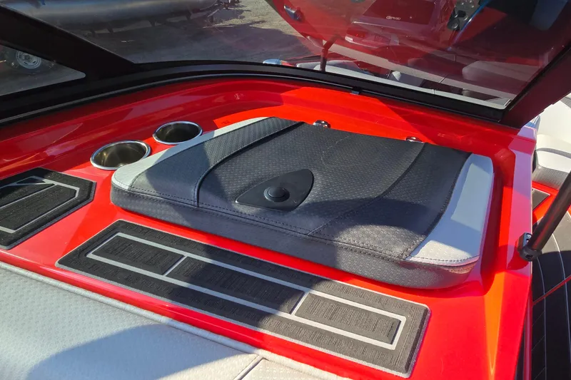 Slide: The Image of 2022 Centurion Fi23 boat interior with red accents and cup holders. - 82