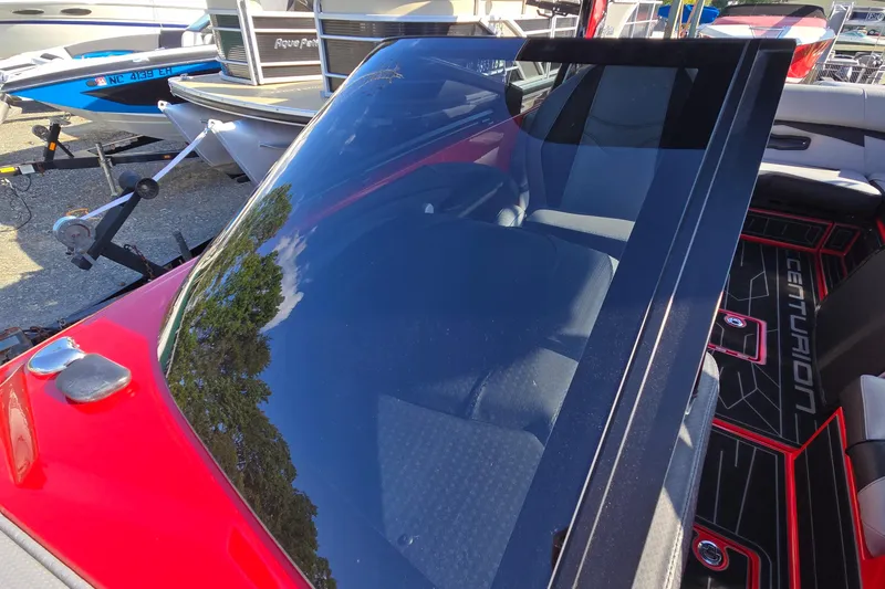 Slide: The Image of 2022 Centurion Fi23 boat interior with red accents and sleek windshield design. - 86
