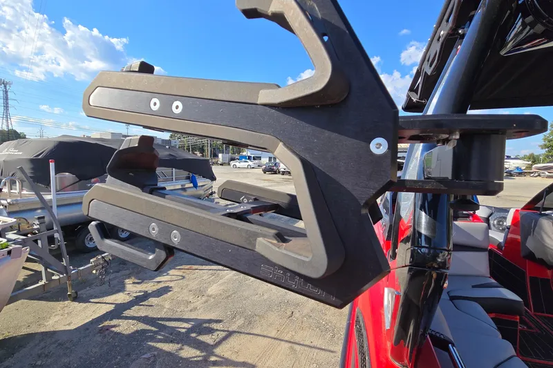 Slide: The Image of 2022 Centurion Fi23 boat with a wakeboard rack, sunny day, outdoor setting. - 87