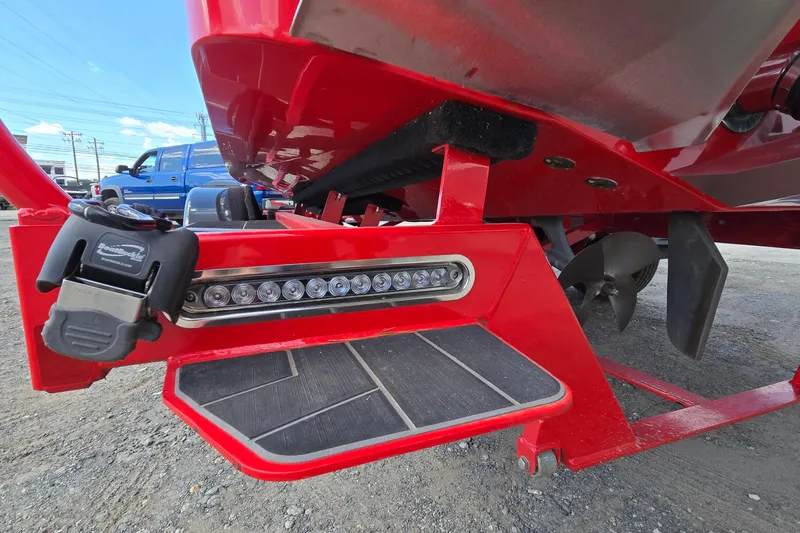 Slide: The Image of Red 2022 Centurion Fi23 boat with step, LED lights, and propeller detail. - 90