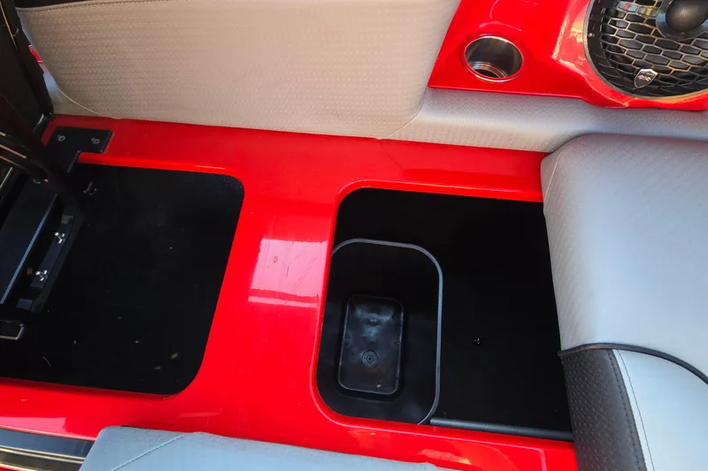 Slide: The Image of Interior of 2022 Centurion Fi23 boat with red accents and speaker. - 96