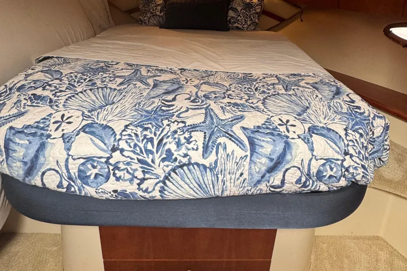 Slide: The Image of Cozy cabin bed in 2008 Cruisers 420 yacht with nautical-themed bedding. - 20