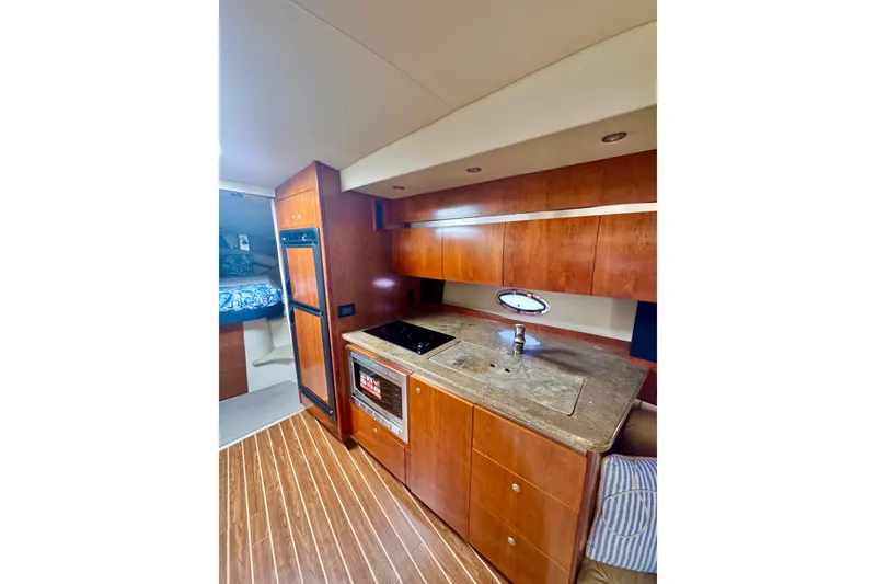 Slide: The Image of Luxurious 2008 Cruisers 420 yacht interior with modern kitchen and wood cabinetry. - 21