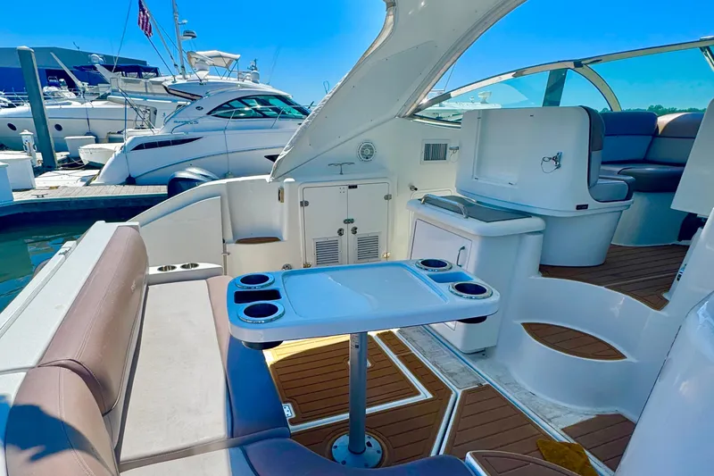 Slide: The Image of Luxurious 2008 Cruisers 420 yacht interior with seating and table, docked at marina. - 6
