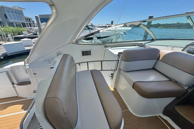 Slide: The Image of 2008 Cruisers 420 yacht interior with beige seating, docked at marina. - 8