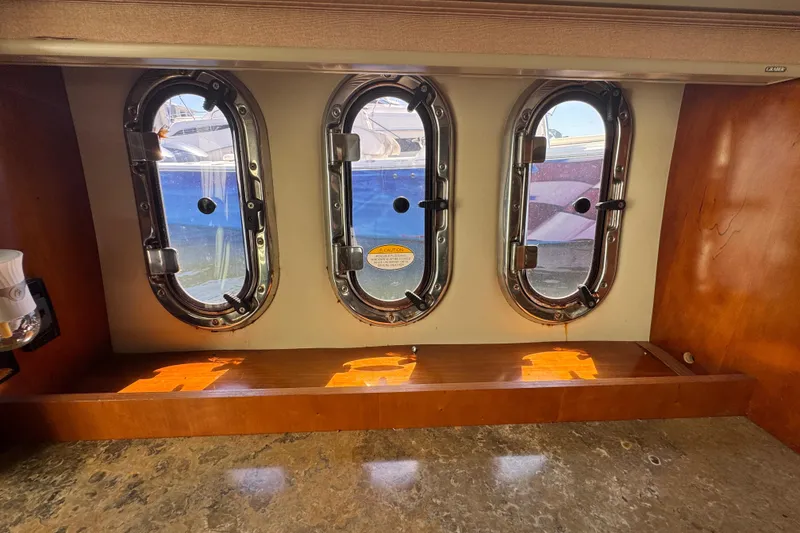 Slide: The Image of Interior view of 2008 Cruisers 420 yacht with three oval portholes. - 16