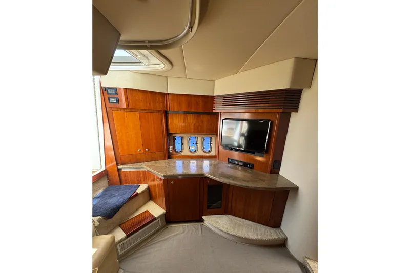Slide: The Image of Interior of 2008 Cruisers 420 yacht with wood cabinetry and mounted TV. - 18