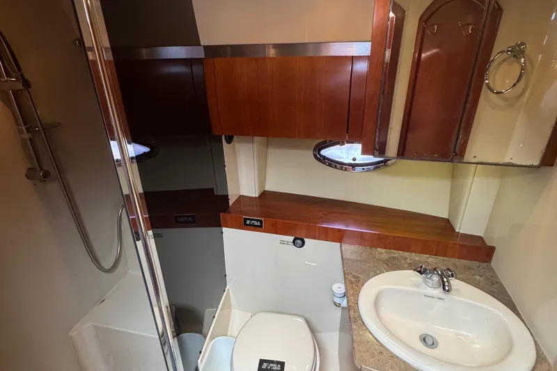 Slide: The Image of 2008 Cruisers 420 yacht bathroom with shower, sink, and wooden cabinetry. - 19