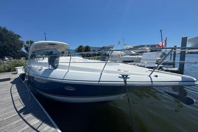 Slide: The Image of 2008 Cruisers 420 yacht docked at marina under clear blue sky. - 4