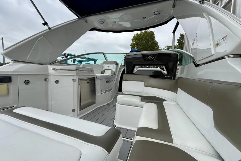 Slide: The Image of 2019 Monterey 295 Sport Yacht interior with sleek seating and modern amenities. - 10