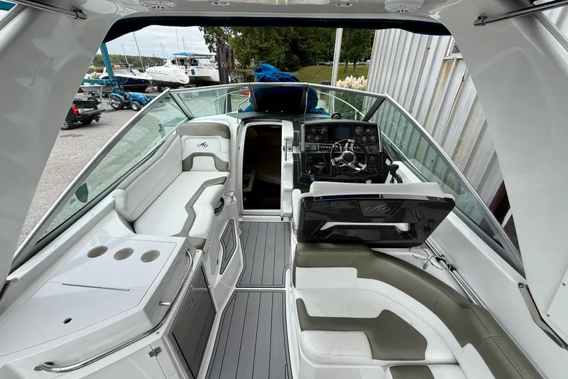 Slide: The Image of 2019 Monterey 295 Sport Yacht interior with helm, seating, and sleek design. - 11
