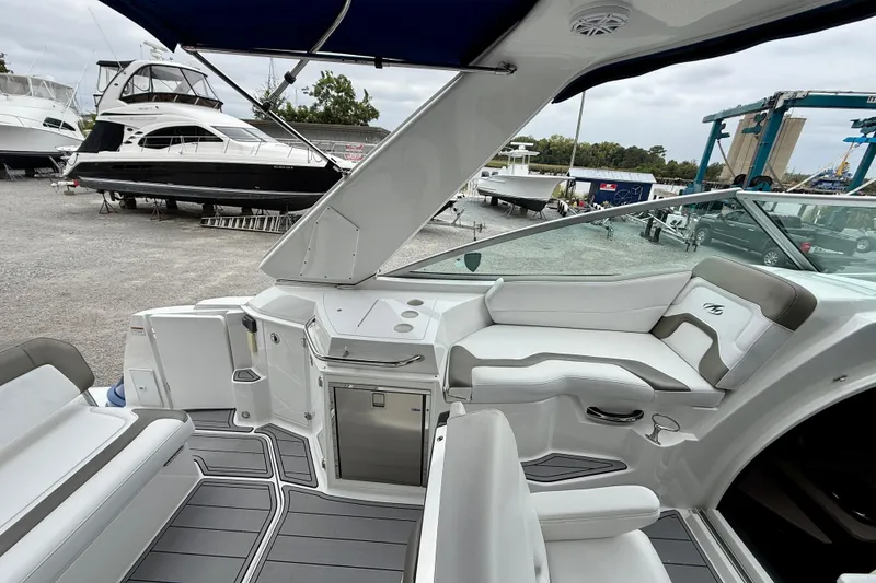 Slide: The Image of 2019 Monterey 295 Sport Yacht interior with sleek seating and modern design. - 13