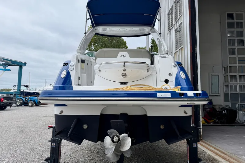 Slide: The Image of 2019 Monterey 295 Sport Yacht in dry dock, rear view with propeller visible. - 6