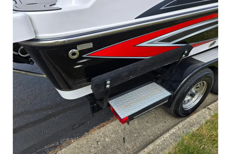 Slide: The Image of 2020 Hurricane SunDeck Sport 202 IO boat with red and black detailing on a trailer. - 10