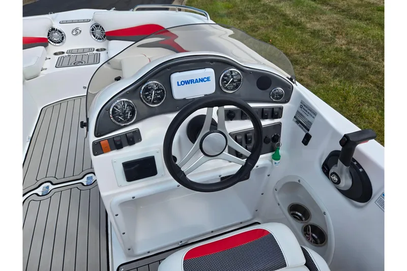 Slide: The Image of 2020 Hurricane SunDeck Sport 202 IO boat dashboard with steering wheel and controls. - 13