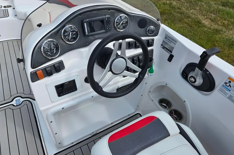 Slide: The Image of 2020 Hurricane SunDeck Sport 202 IO boat dashboard with steering wheel and controls. - 14