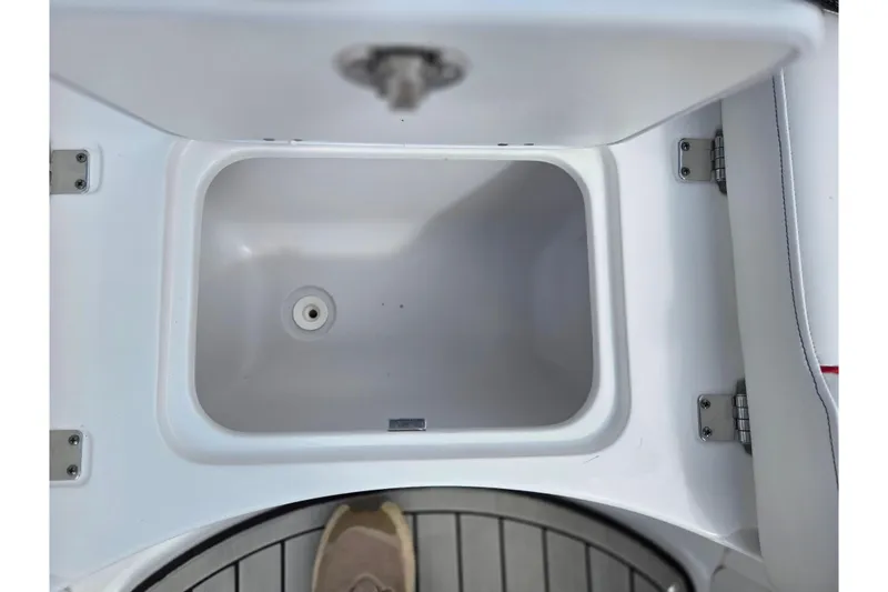 Slide: The Image of 2020 Hurricane SunDeck Sport 202 IO boat storage compartment, open lid, white interior. - 20
