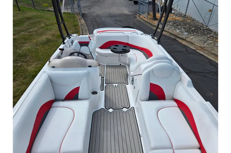 Slide: The Image of 2020 Hurricane SunDeck Sport 202 IO boat interior with white and red seating, gray flooring. - 23
