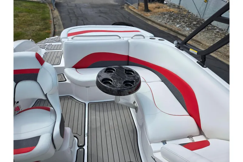 Slide: The Image of 2020 Hurricane SunDeck Sport 202 IO boat interior with red and white seating and cup holders. - 25