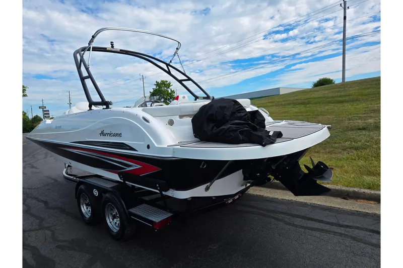 Slide: The Image of 2020 Hurricane SunDeck Sport 202 IO boat on trailer, parked outdoors. - 3