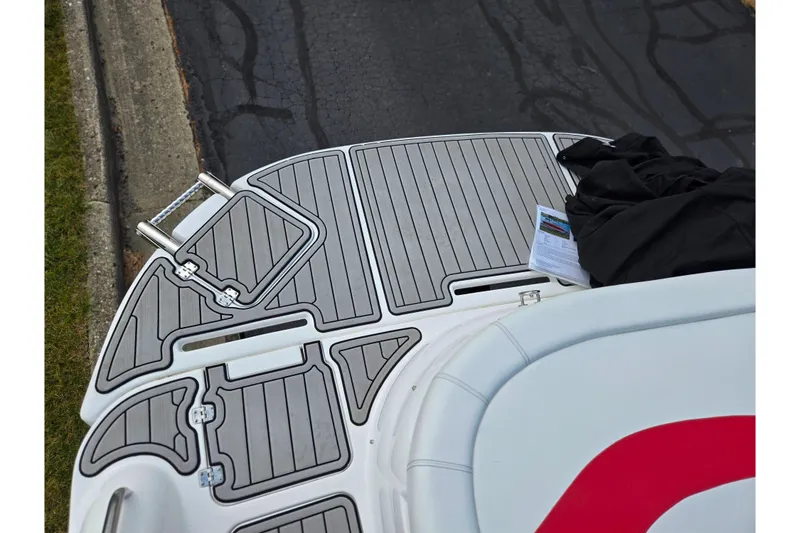 Slide: The Image of 2020 Hurricane SunDeck Sport 202 IO boat deck with gray non-slip surface and accessories. - 30